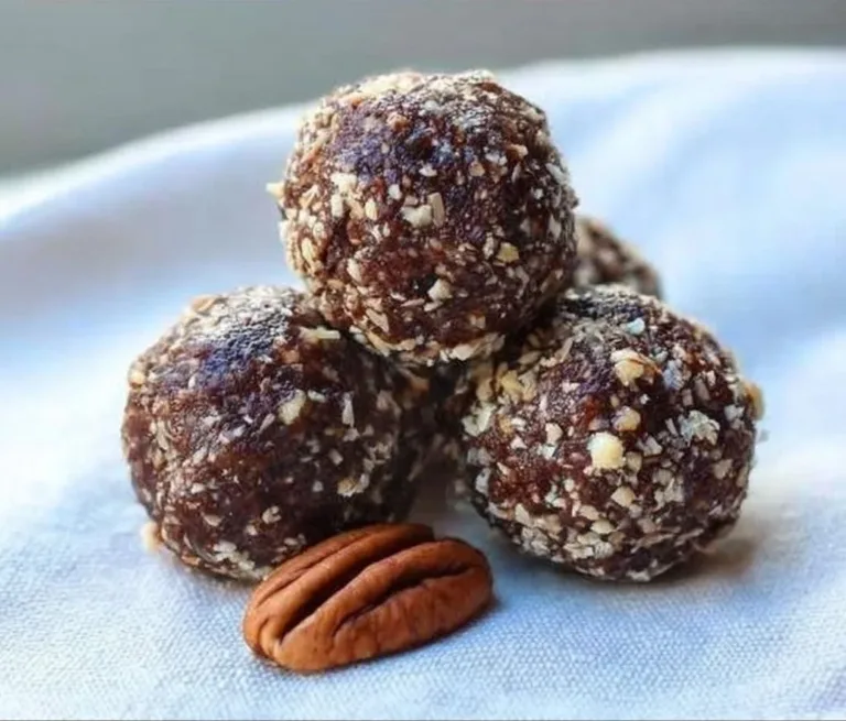 Homemade Chocolate Date Energy Balls stacked on a wooden board