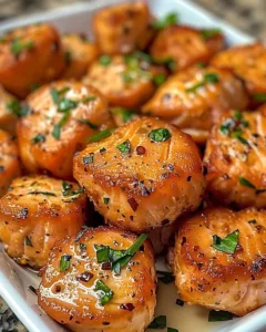 Bang Bang Salmon Bites served on a platter with sauce and garnishes