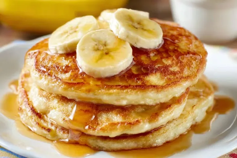 Banana Pancakes potato cakes Fluffy banana pancakes stacked and served with syrup and fresh fruit