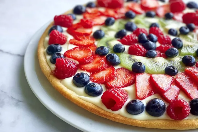 Fourth of July fruit pizza topped with vibrant berries and star-shaped fruits