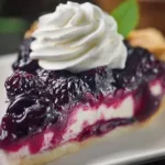 A delicious slice of wild black raspberry pie topped with fresh berries.