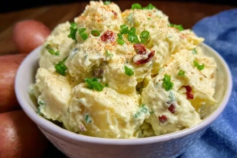 Old-Fashioned Potato Salad Peach Cream Cheese Tarts Bowl of old-fashioned potato salad with eggs, pickles, and herbs